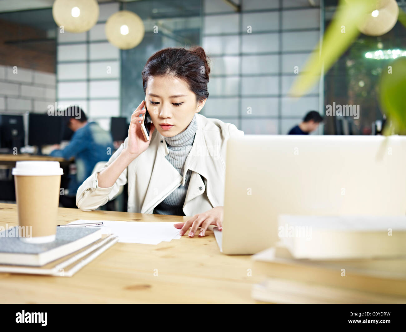 young asian office worker calling in office Stock Photo Alamy
