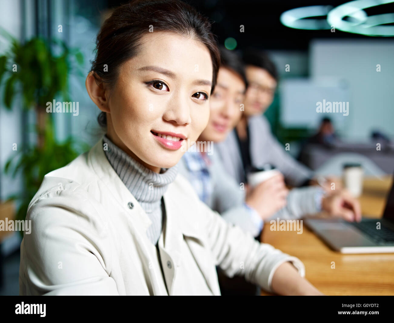 portrait of a young asian business woman looking at camera during meeting in office. Stock Photo