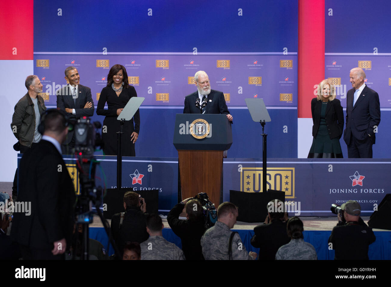 Washington DC, USA. 5th May, 2016. Former Late Show Host David Letterman does a stand up routine during a comedy show in celebration of the 75th anniversary of the USO and the 5th anniversary of Joining Forces at Joint Base Andrews May 5, 2016 in Washington, D.C. Joining Letterman on stage are (L-R): Comedian Jon Stewart, President Barack Obama, First Lady Michelle Obama, Dr. Jill Biden and Vice President Joe Biden. Credit:  Planetpix/Alamy Live News Stock Photo
