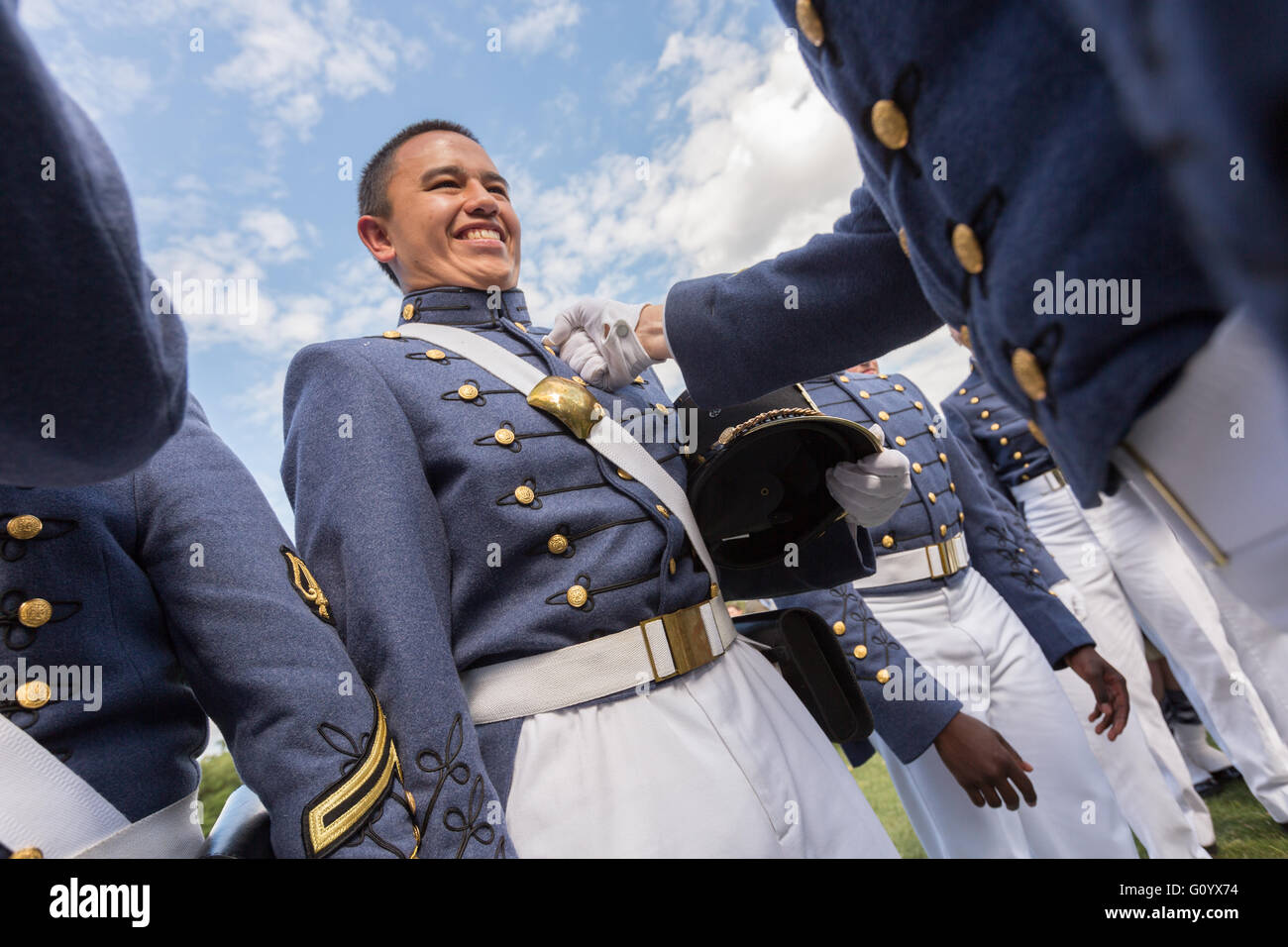 Graduating senior cadets with the Summerall Guards celebrate the brassing of the buckle on underclassmen following the Long Grey Line graduation parade at the Citadel military college May 6, 2016 in Charleston, SC. Brassing involves punching or scratching the brass uniform buckle to remember the departing senior. Stock Photo