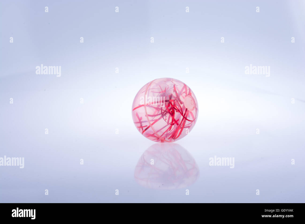 Red transparent ball  with red htreads in placed on white background Stock Photo