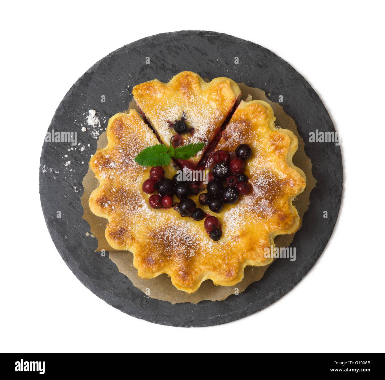 Close up of berry pie on modern slate plate isolated on white background Stock Photo