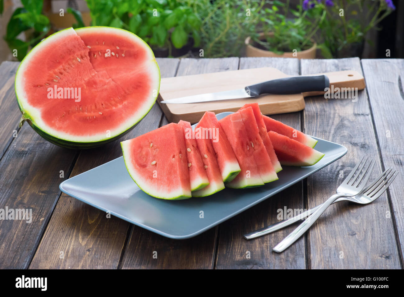 Slices of watermelon on wooden table in rustic style Stock Photo