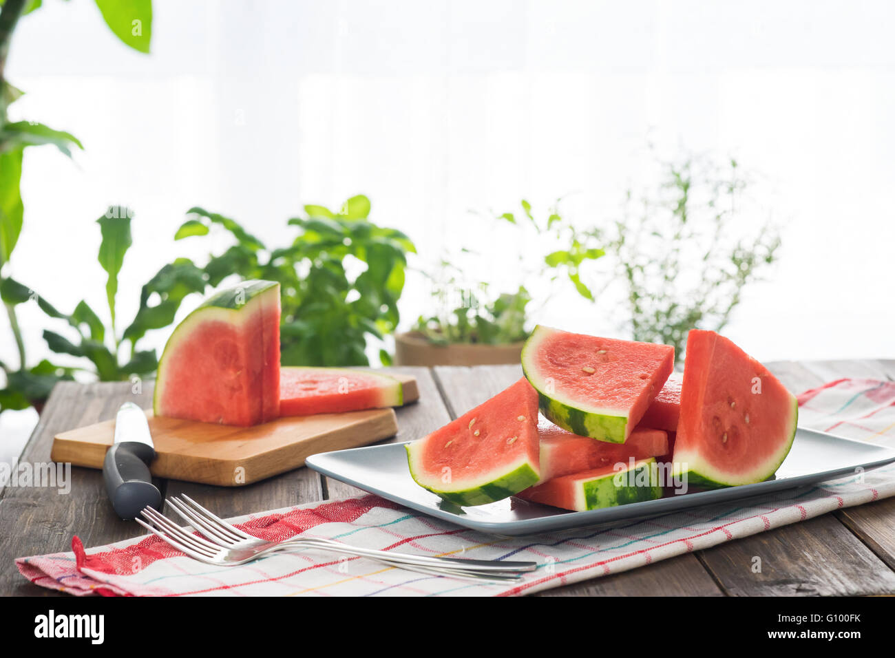 Slices of watermelon on wooden table in rustic style Stock Photo