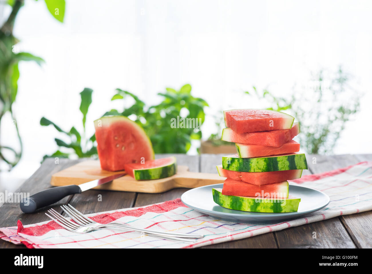 Slices of watermelon on wooden table in rustic style Stock Photo