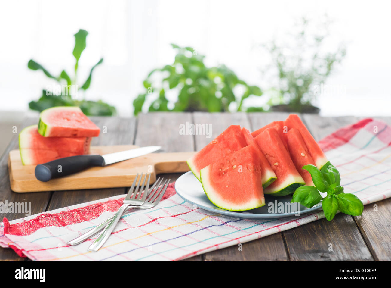 Slices of watermelon on wooden table in rustic style Stock Photo