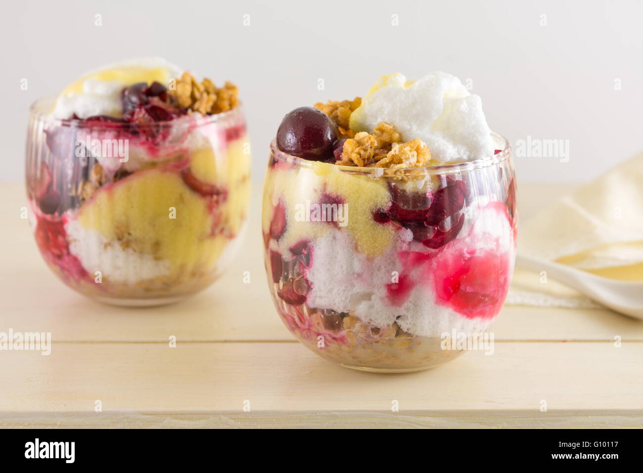 Homemade granola parfait with cherries and cream. Healthy dessert Stock Photo