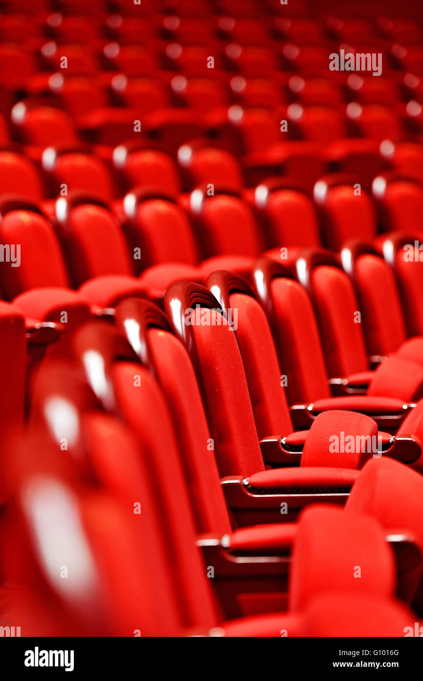 Rows of empty red velvet seats inside a theater Stock Photo - Alamy