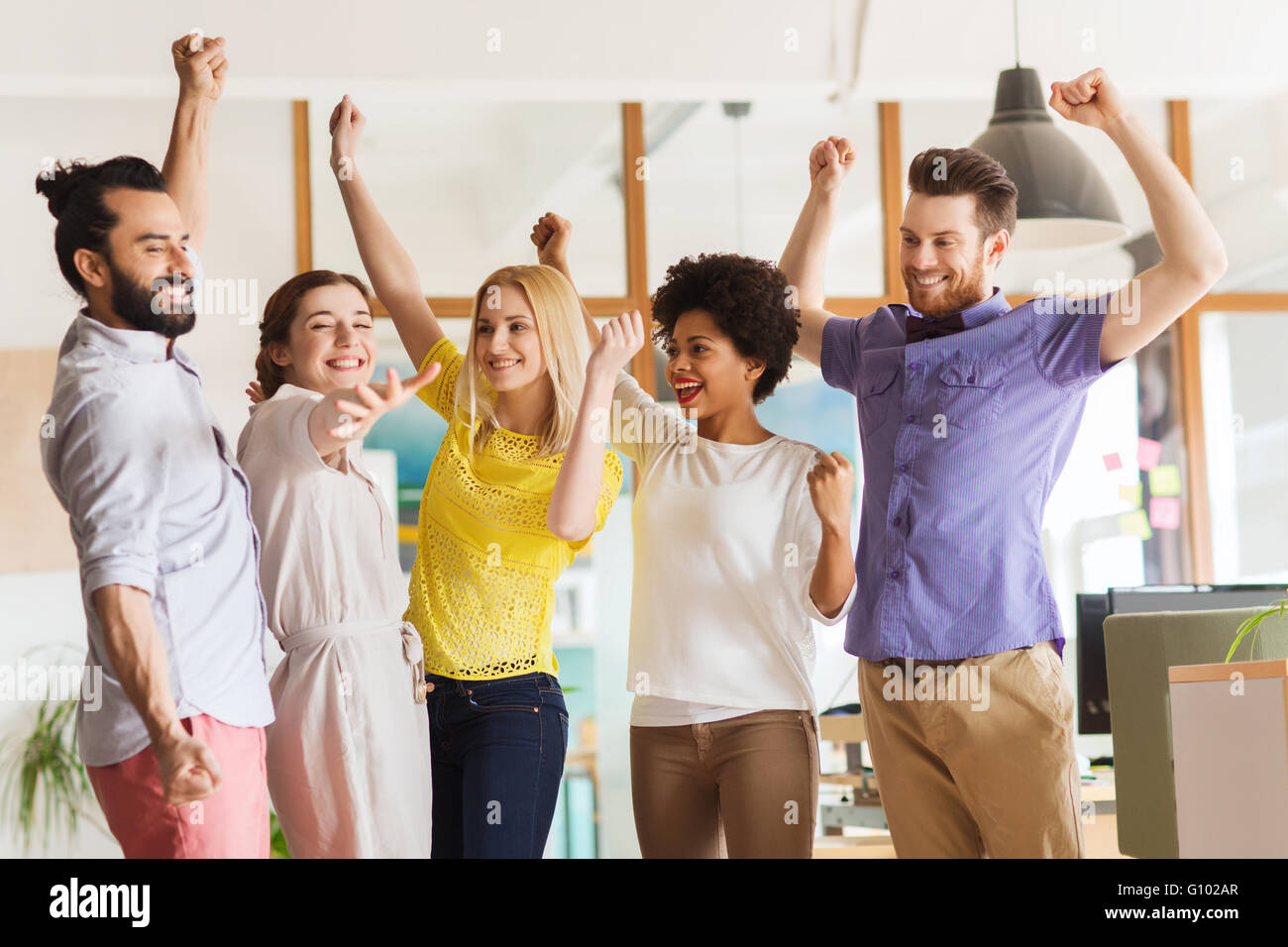 happy creative team celebrating victory in office Stock Photo - Alamy