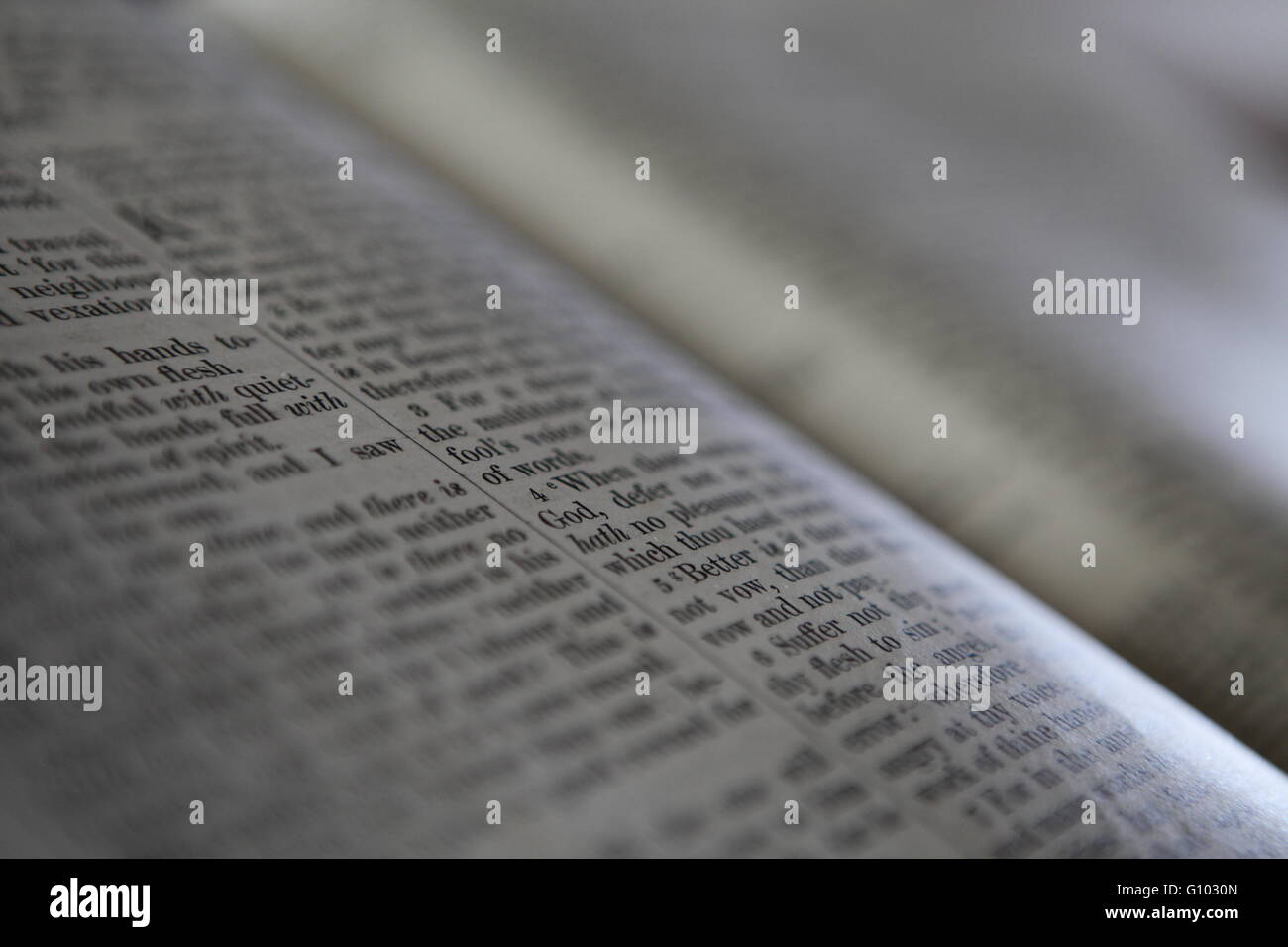 Small depth of field on Bible page in a church Stock Photo