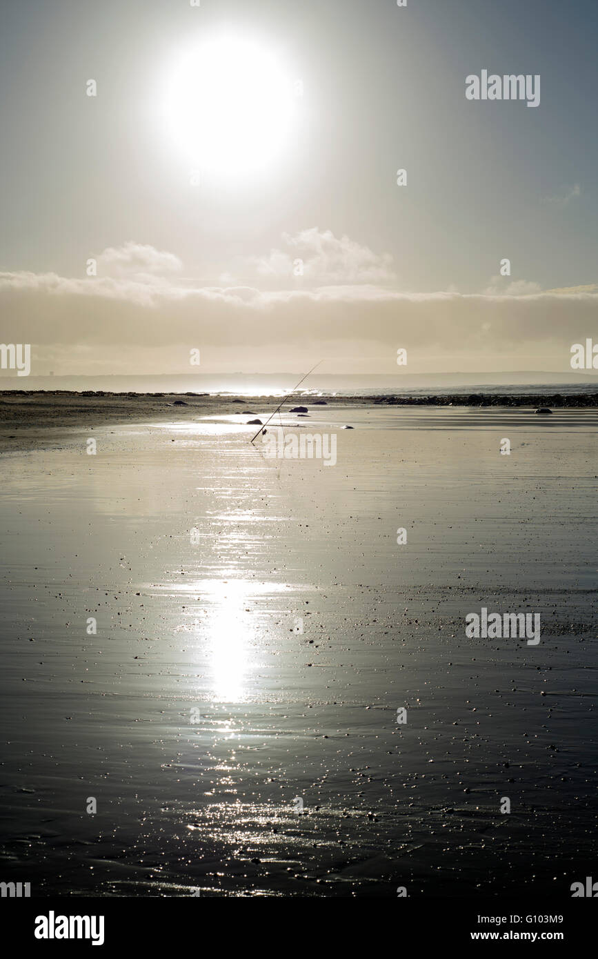 mounted fishing rod on a sunset beach in county Kerry Ireland Stock