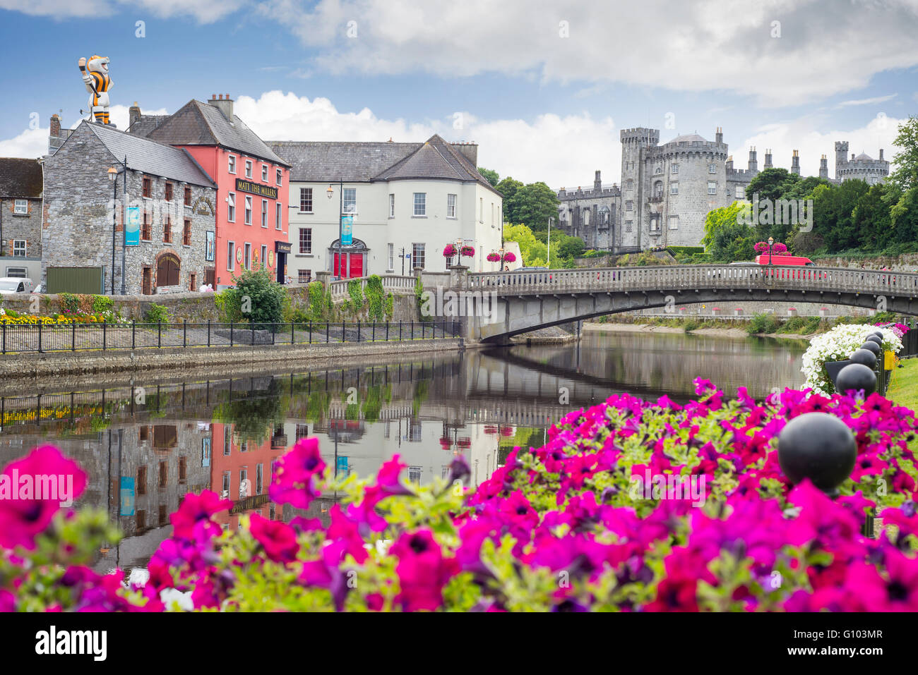 beautiful flower lined riverside view of kilkenny castle town and bridge Stock Photo