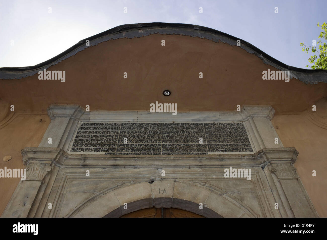 Wide view of IMARET's Arabic script inscription placed over a door entrance of the complex and roof details. Kavala, Greece Stock Photo