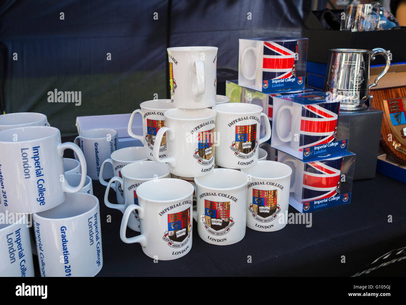 Souvenir mugs with crests and logos on sale at a stall in Imperial College, South Kensington, London before a graduation ceremony in Imperial College Stock Photo