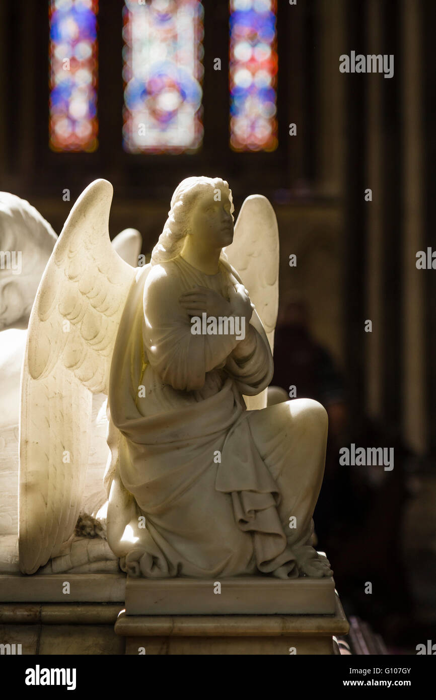 A backlit alabaster angel on a tomb in Worcester Cathedral Stock Photo