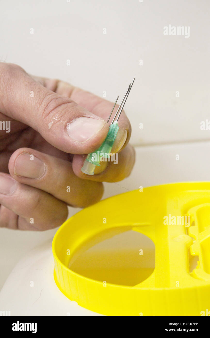 Hand pulling needles recycling Stock Photo Alamy