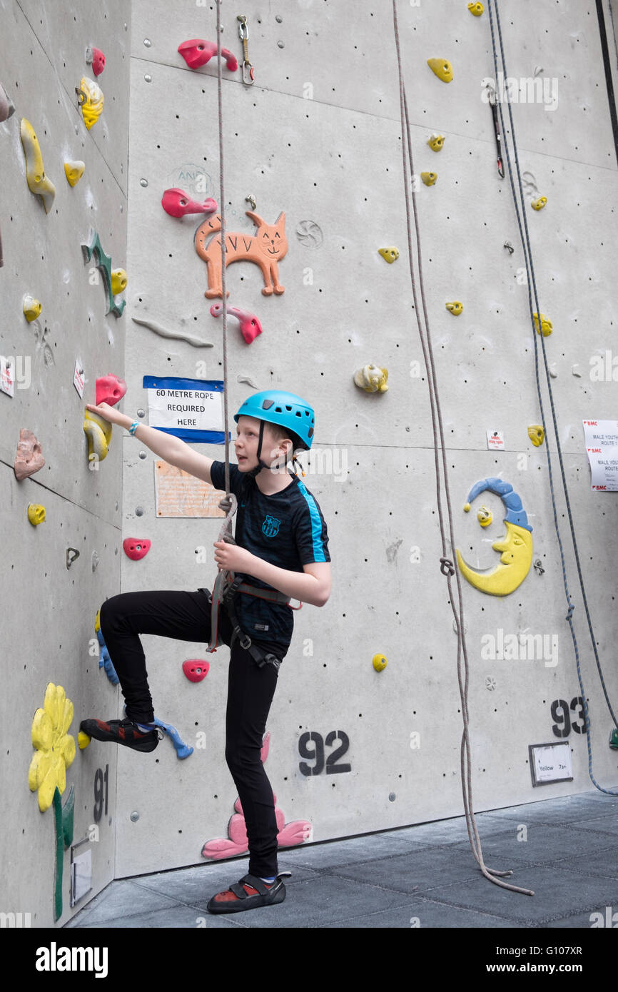 A young boy climbing at the national indoor climbing centre in Ratho