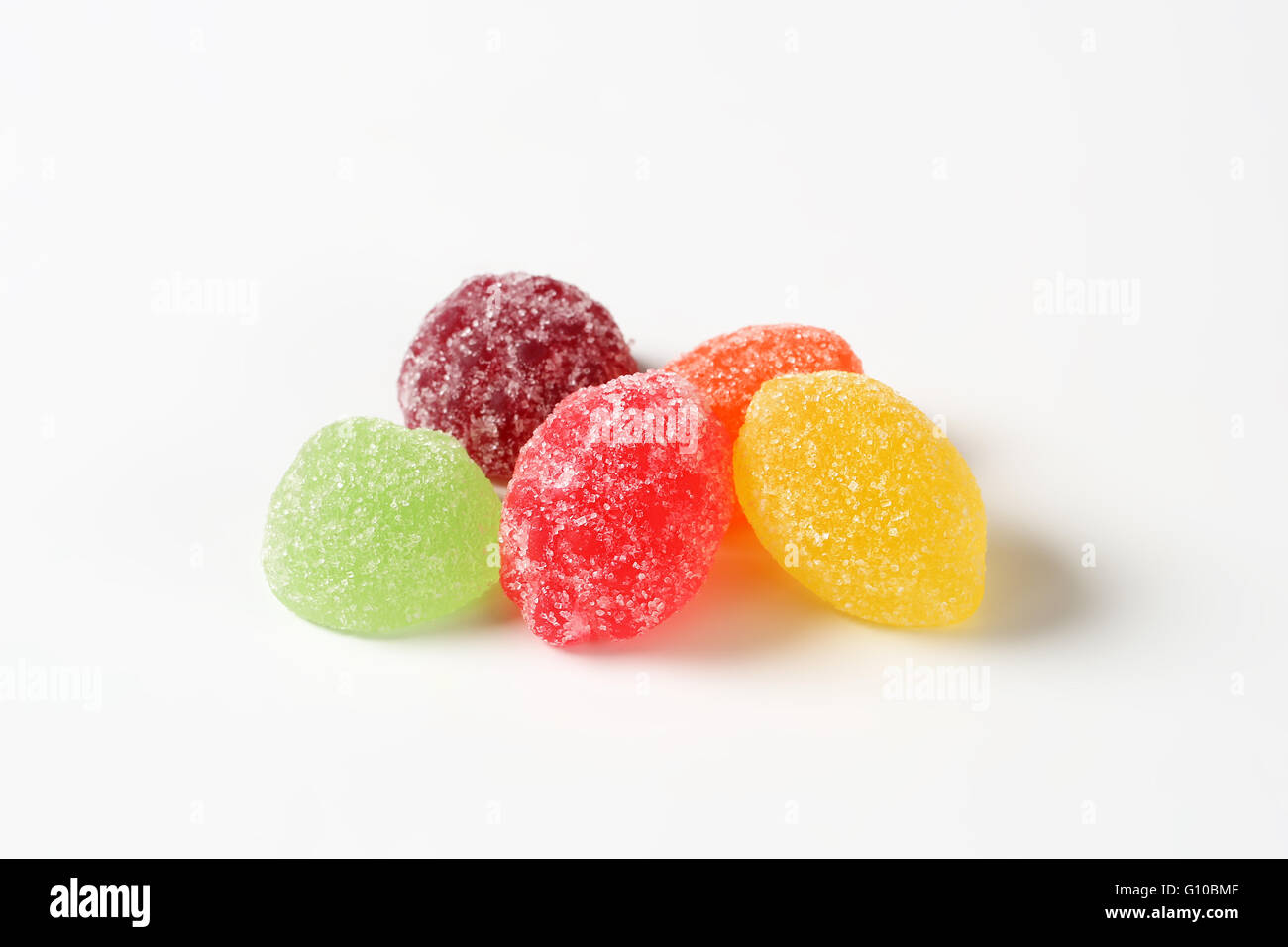 fruit jelly candies coated with sugar on white background Stock Photo
