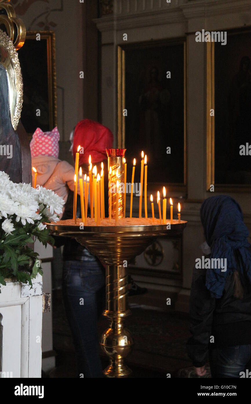 golden candlestick full of burn candles on Sunday worship in orthodox
