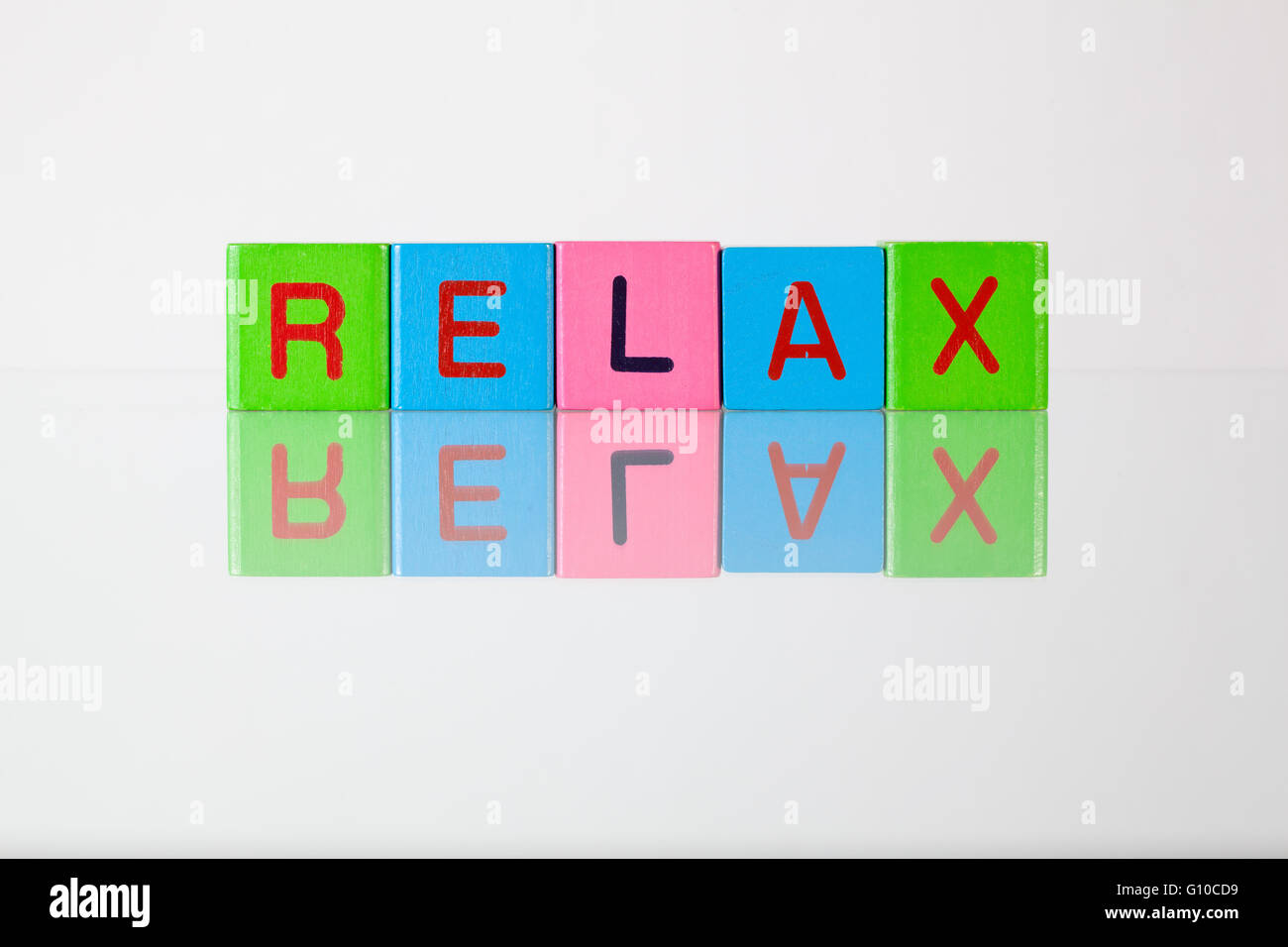 Relax - an inscription from children's wooden blocks Stock Photo