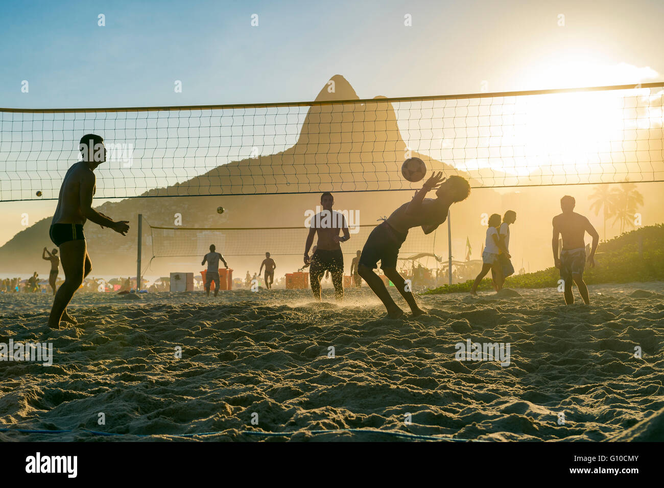 RIO DE JANEIRO - MARCH 27, 2016: Brazilians play beach futevôlei (footvolley), a sport combining football/soccer and volleyball. Stock Photo