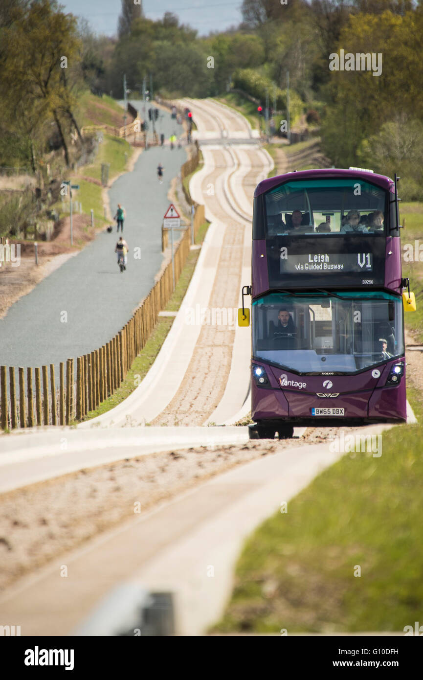 Purple bus on new guided busway driver and passengers visible Stock Photo