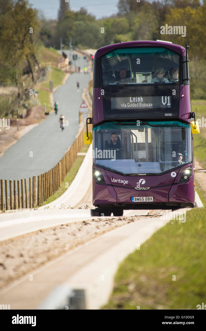 Purple bus on new guided busway driver and passengers visible Stock Photo
