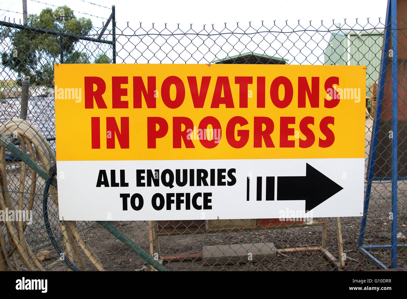 Renovation in Progress signboard against the fence Stock Photo
