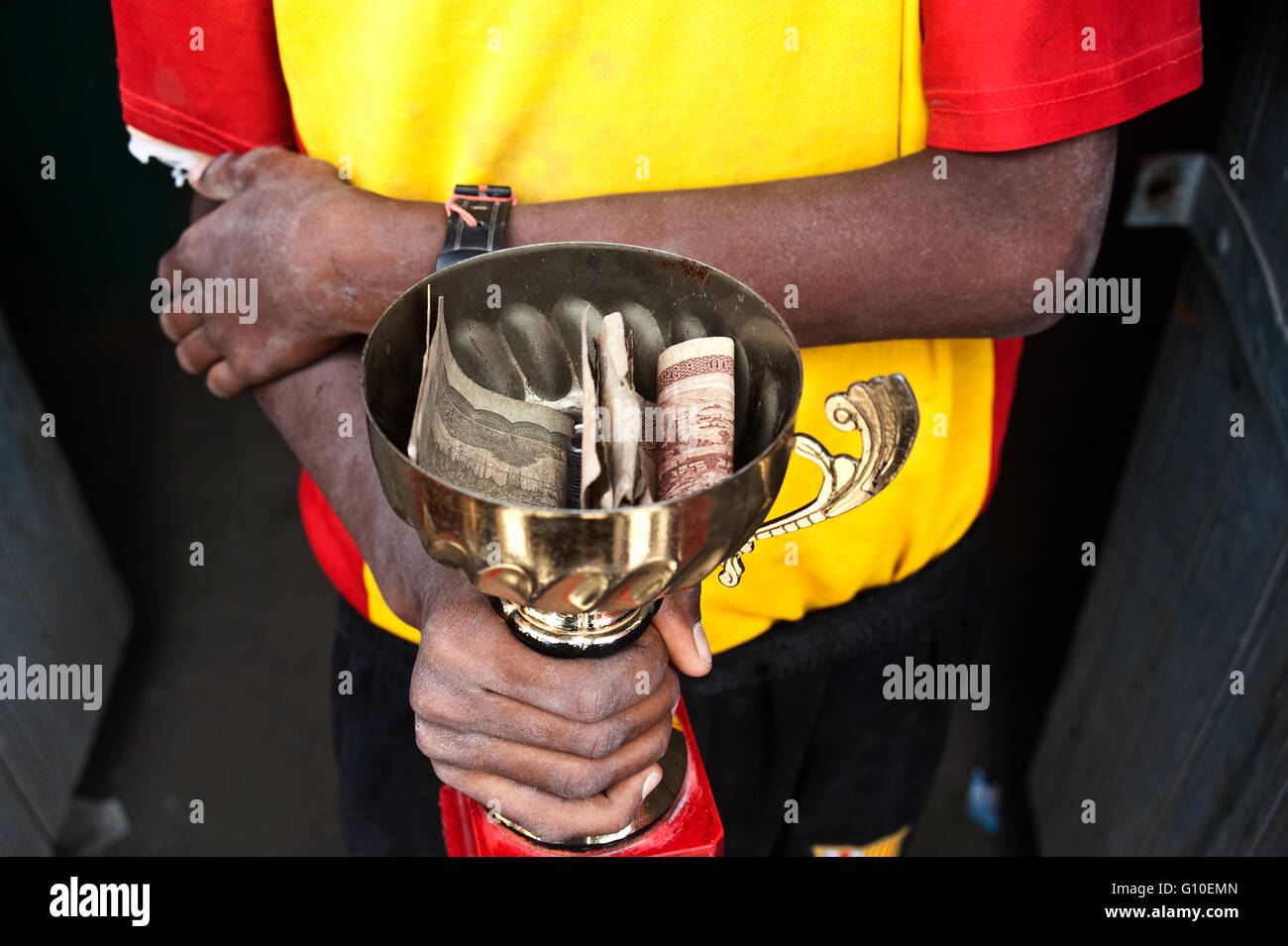 Boy finding money to finance his football team . From Ethiopia. Stock Photo