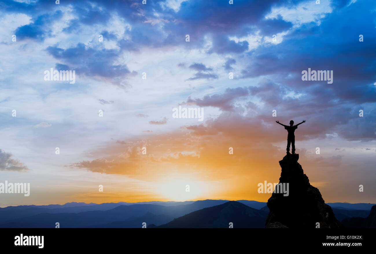man on the top of a rock Stock Photo