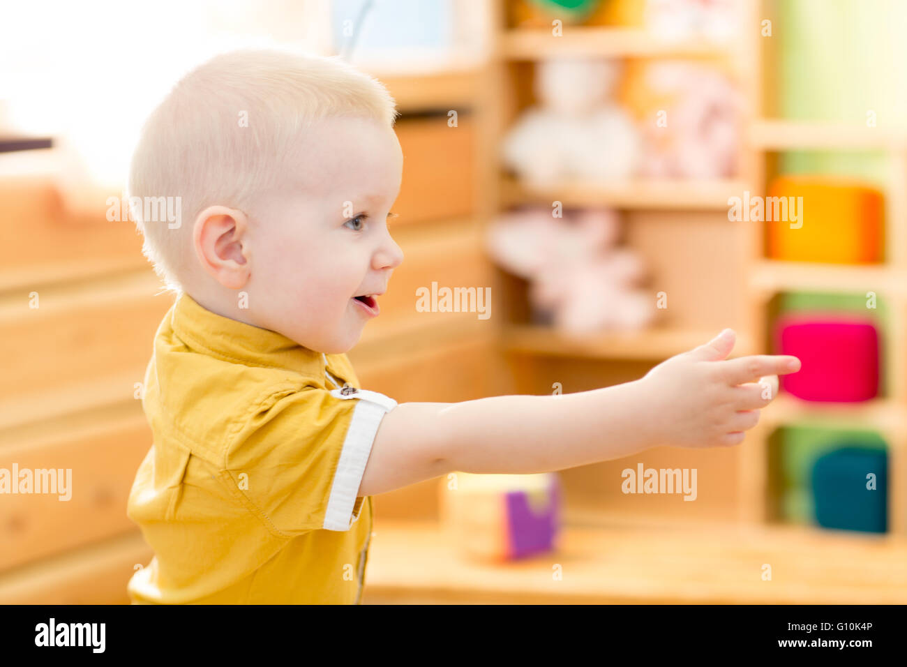 Happy kid playing in kindergarten room Stock Photo