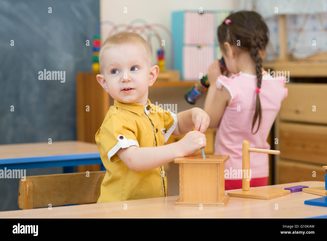 Pensive kid playing in kindergarten Stock Photo