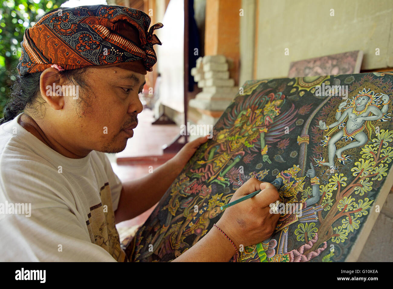 Artist painting traditional figures Ubud Bali Indonesia Stock Photo