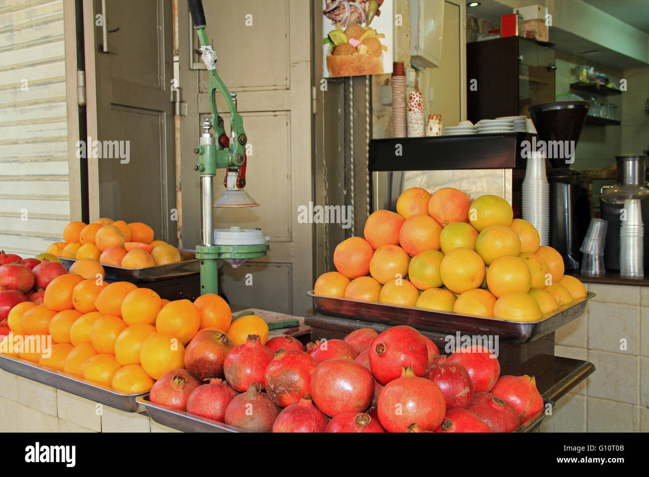 An open air drink stand with oranges and pomegranates in the Christian quarter of Old Jerusalem, Israel. Stock Photo
