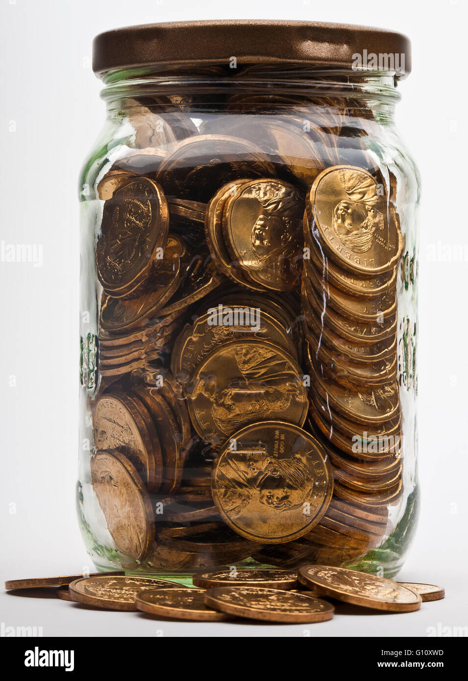 jar full of dollar gold coins Stock Photo