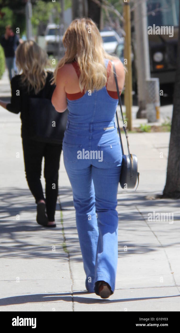 Hilary Duff wearing tight denim overalls while running errands in