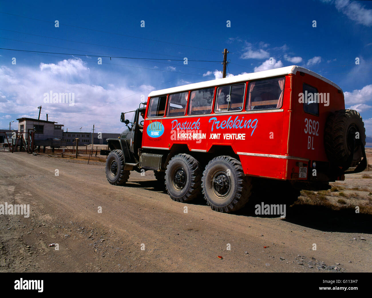 Torugart Pass Kyrgyzstan Entry Gate to Kyrgyzstan & Dostuck Trekking Adventure Travel Company Truck - Kyrgyz British Joint Venture Stock Photo