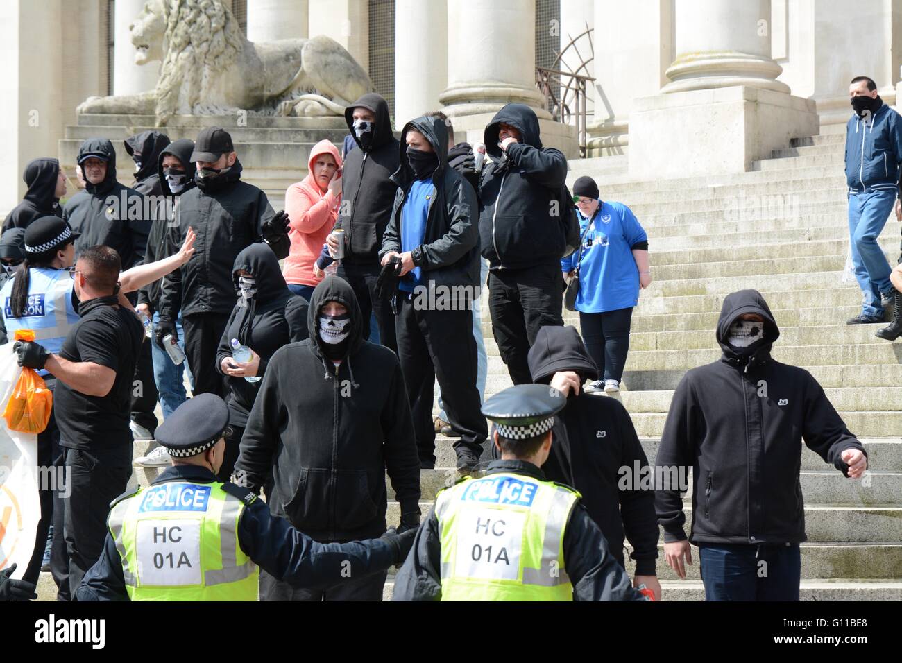 Portsmouth, UK. 7th May 2016. Masked protesters stand as they gesture to anti-fascist groups. Credit: Marc Ward/Alamy Live News Stock Photo