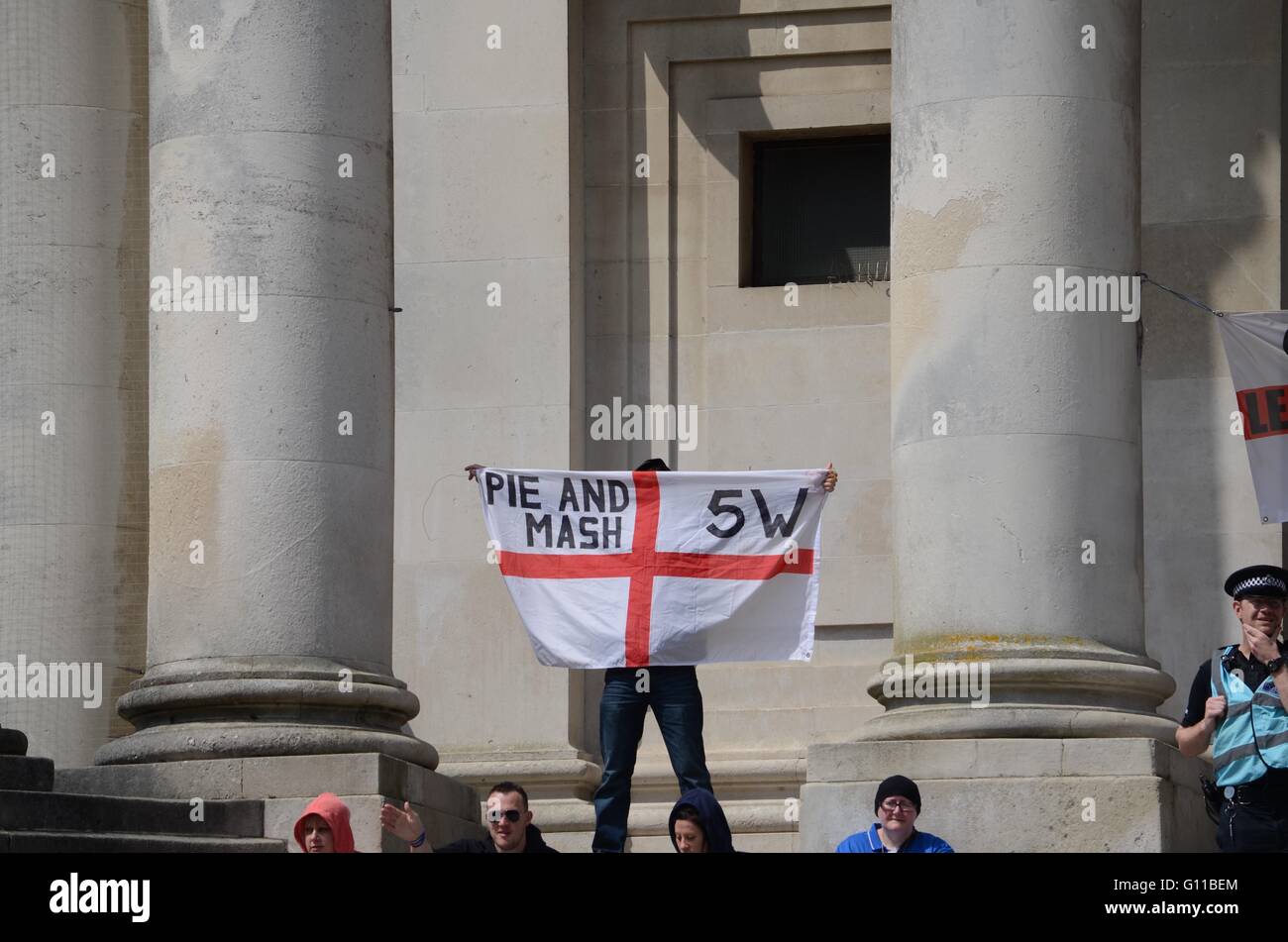 Portsmouth, UK. 7th May 2016. Pie and Mash member holds a St Georges Day flag with 5w (N.B 5W is the following 5 words: 'We Go Where We Want') Credit: Marc Ward/Alamy Live News Stock Photo