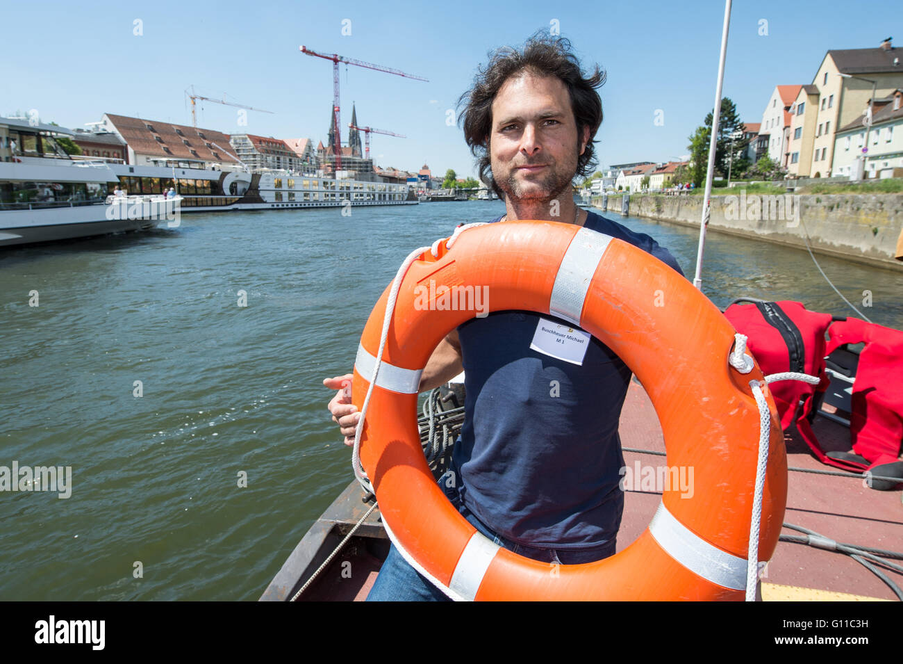Regensburg, Germany. 07th May, 2016. The initator of the refugee initiative 'Sea Eye, ' Michael Buschheuer, stands on a boat on the Danube river during a rescue drill in Regensburg, Germany, 07 May 2016. The members of 'Sea Eye, ' a private sea rescue for refugees in the Mediterranean Sea, drilled rescue efforts in Regensburg. Photo: ARMIN WEIGEL/dpa/Alamy Live News Stock Photo