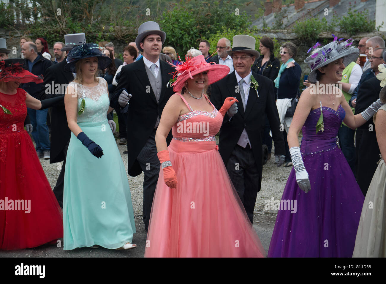 Helson, Cornwall, UK. 7th May 2016. Some eighty couples dance through the streets of Helston, entering selected houses and shops to drive out the darkness of winter and bring in the light of spring. The music to the Furry dance is played by Helston Town band, was made into a vocal version 'The floral dance' by the late Sir Terry Wogan. The colourful Pageant, known as Hal an Tow, tells the history of Helston with the participating characters singing about the challenge of the Spanish Armada, the English patron saint, St. Credit:  Simon Maycock/Alamy Live News Stock Photo