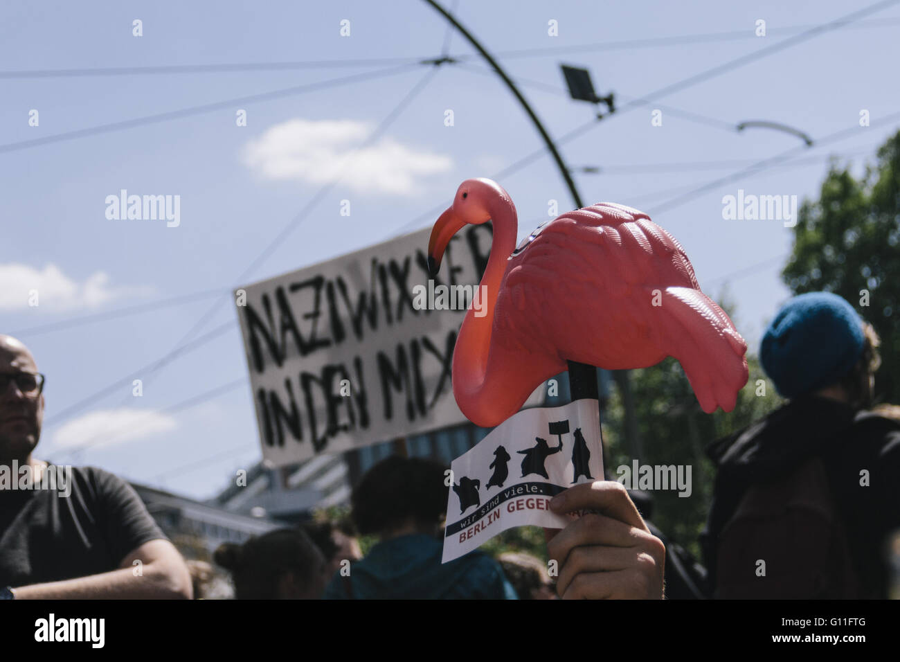 Berlin, Berlin, Germany. 7th May, 2016. A protester holhing a pink flamingo during the counter protests against the rally held under the motto 'Merkel muss weg![Merkel must go]' organised by far-right group 'We for Berlin & We for Germany' Credit:  Jan Scheunert/ZUMA Wire/Alamy Live News Stock Photo