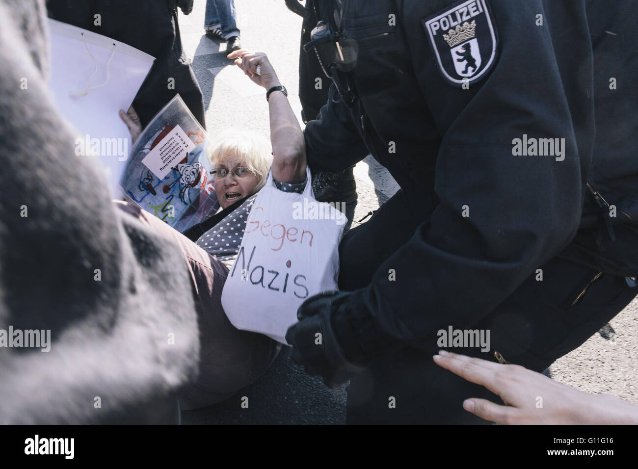 Berlin, Berlin, Germany. 7th May, 2016. An elderly woman in conflict with the police during counter protests against the rally held under the motto 'Merkel muss weg![Merkel must go]' organised by far-right group 'We for Berlin & We for Germany' Credit:  Jan Scheunert/ZUMA Wire/Alamy Live News Stock Photo