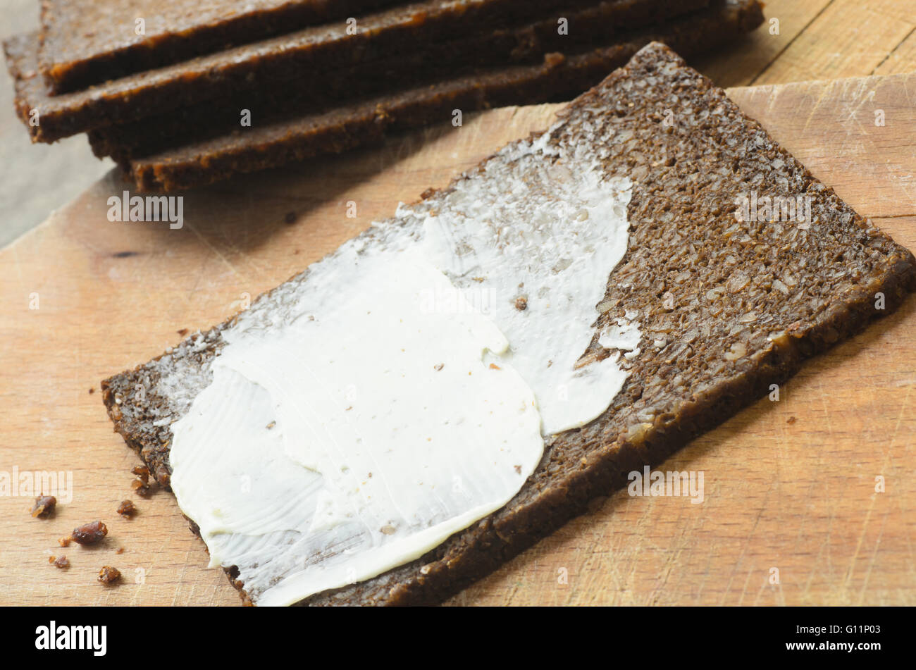 pumpernickel bread and butter on wooden table Stock Photo Alamy