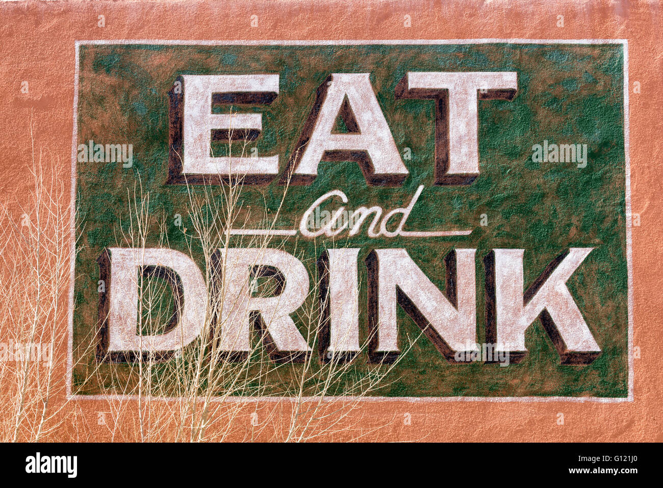 Eat and drink sign on the wall of The Yucca Bar in Carrizozo, New Mexico. Stock Photo