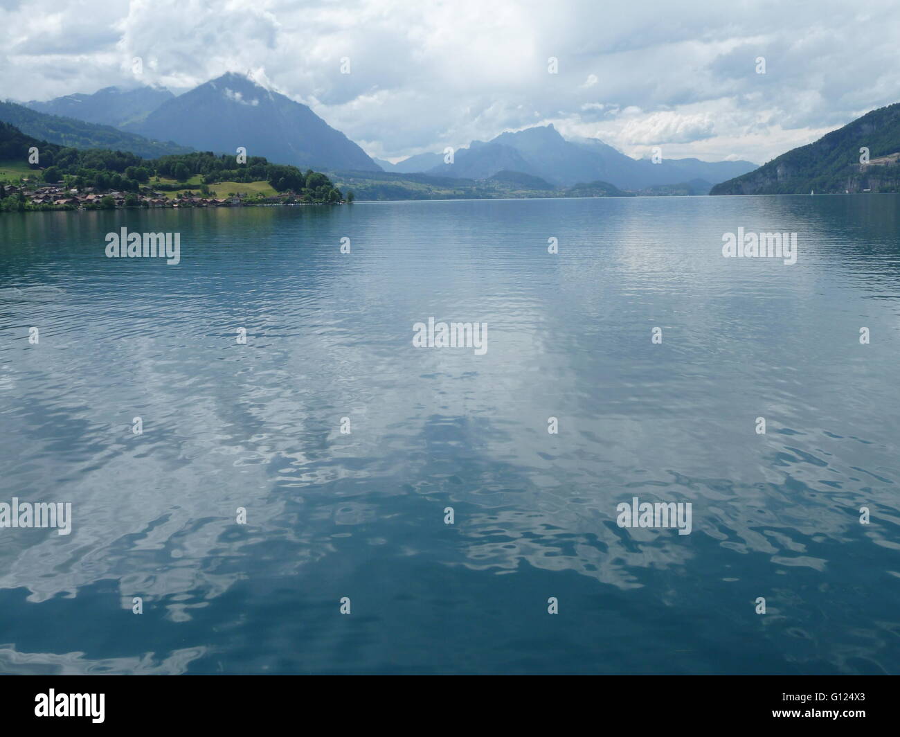 Thunersee lake, Switzerland on a calm summer's day with Niesen mountain in the distance Stock Photo