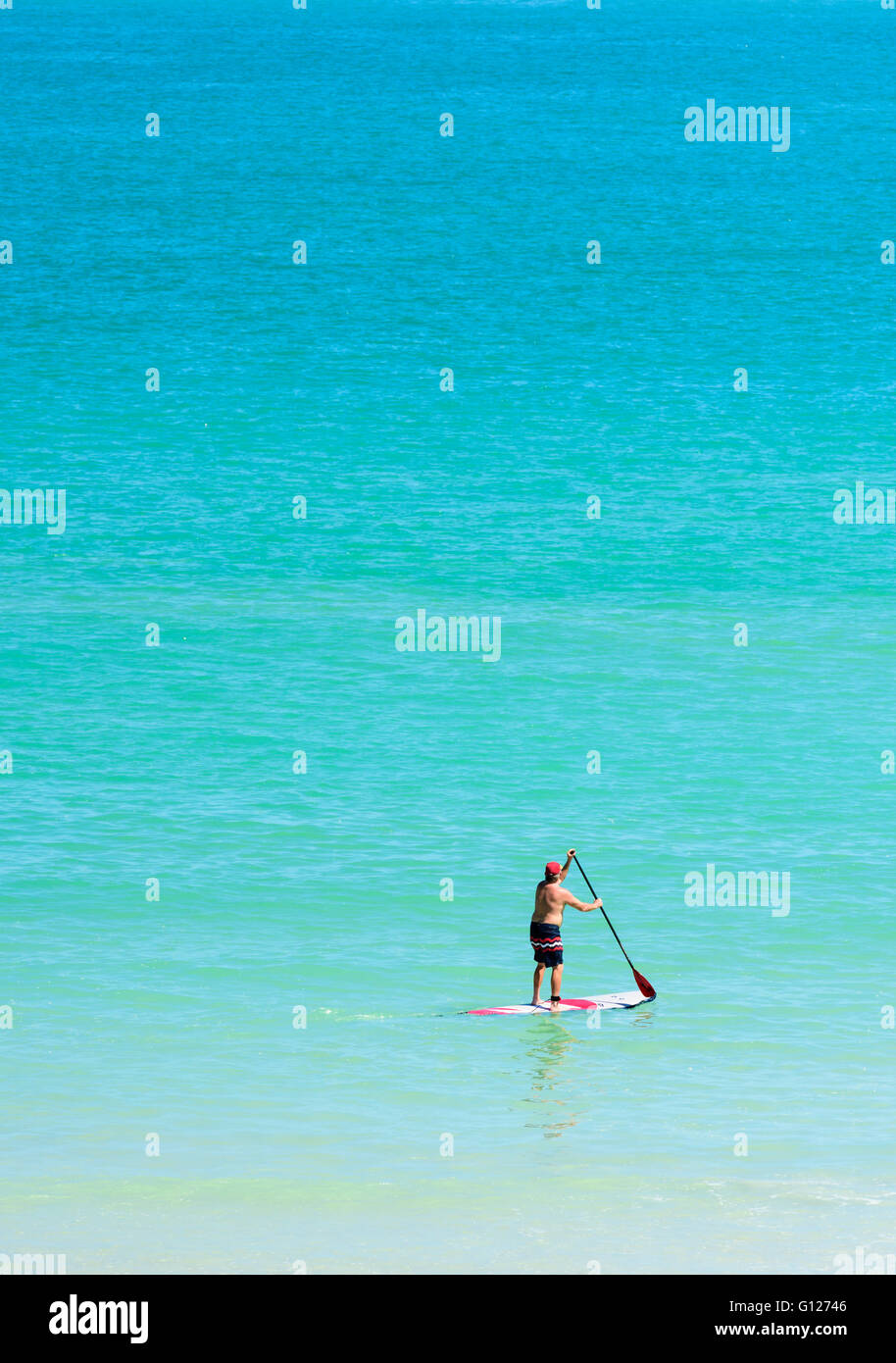 A man Stand Up Paddling off Cable Beach, Broome, Kimberley, Western Australia Stock Photo