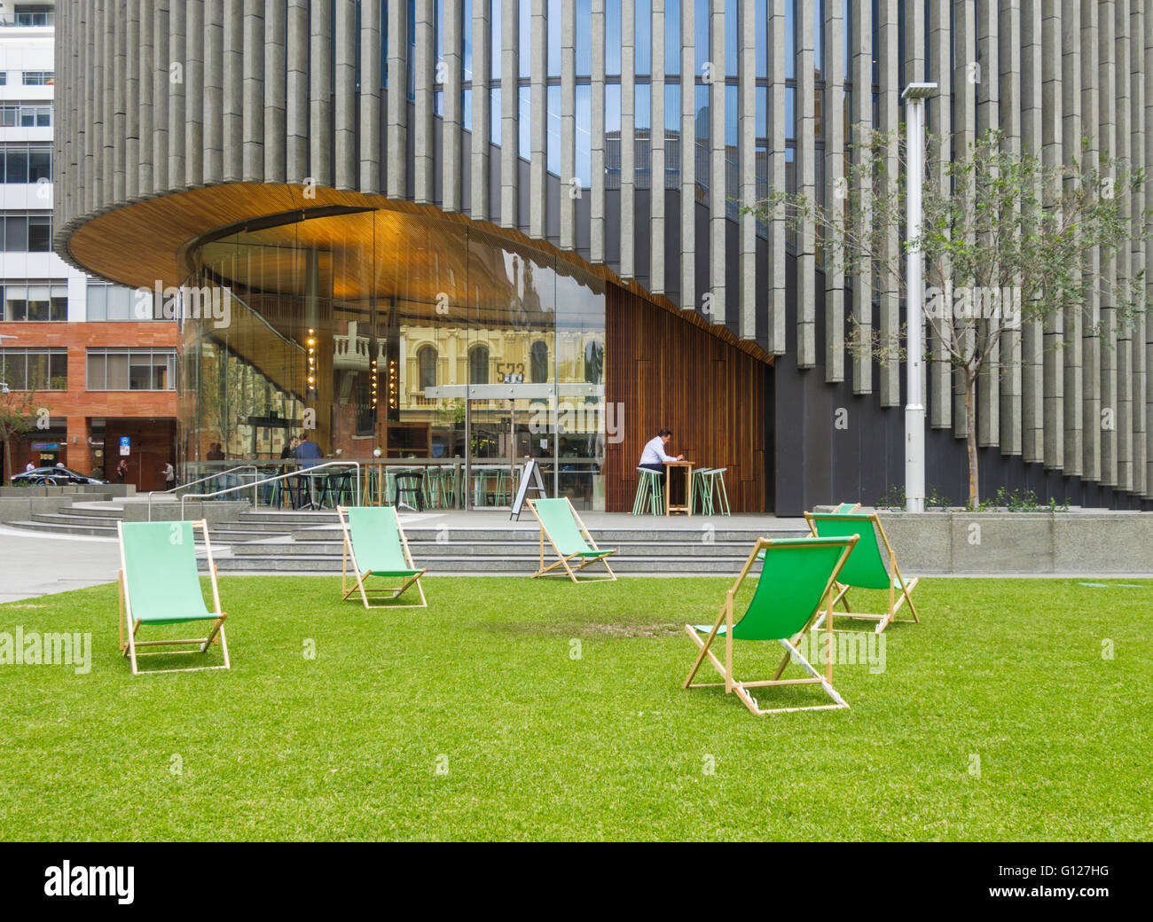 Deckchairs on the Cathedral Square lawn outside the new City of Perth Library, Hay Street, Perth, Western Australia, Australia Stock Photo