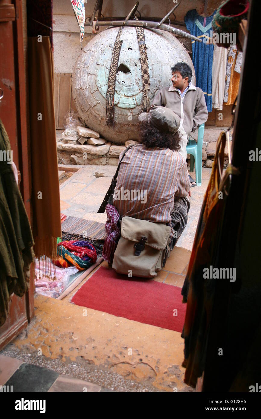 Man on holidays, travelling through India sitting on a step with a canvas bag Stock Photo