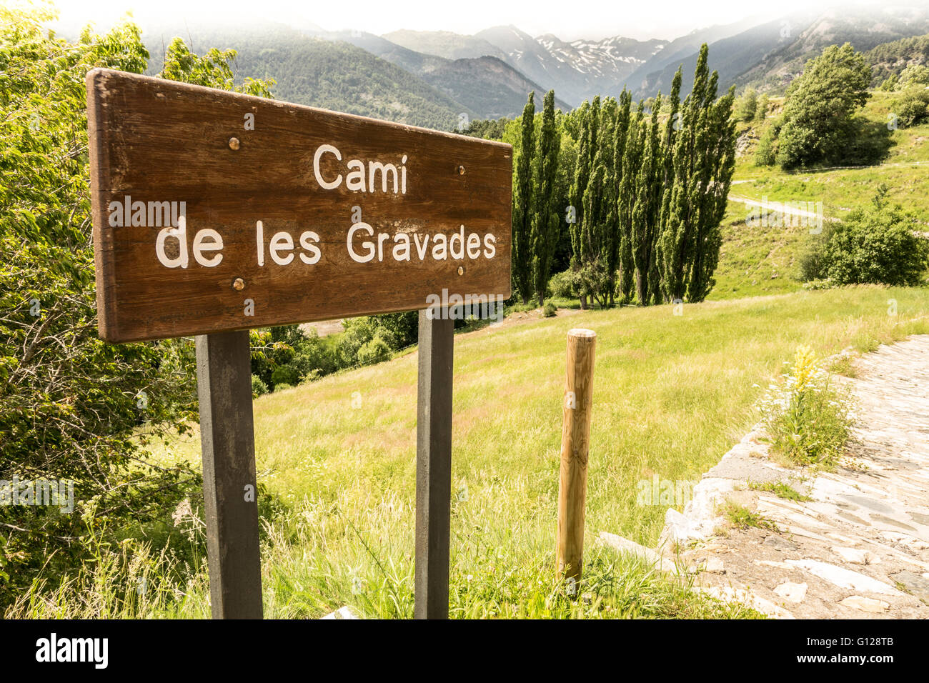 Footpath sign in Anyos, Andorra. Pyrenean mountains in the background 
